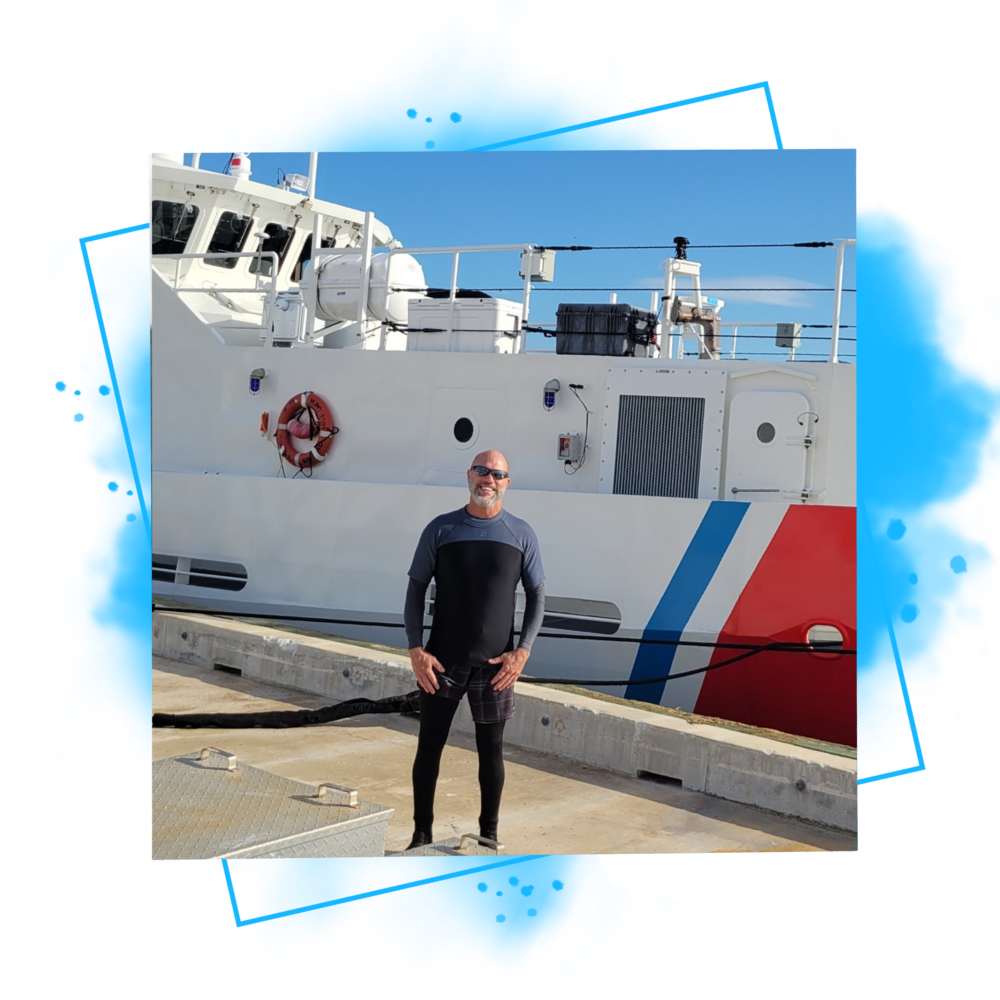 A man standing in front of a boat.